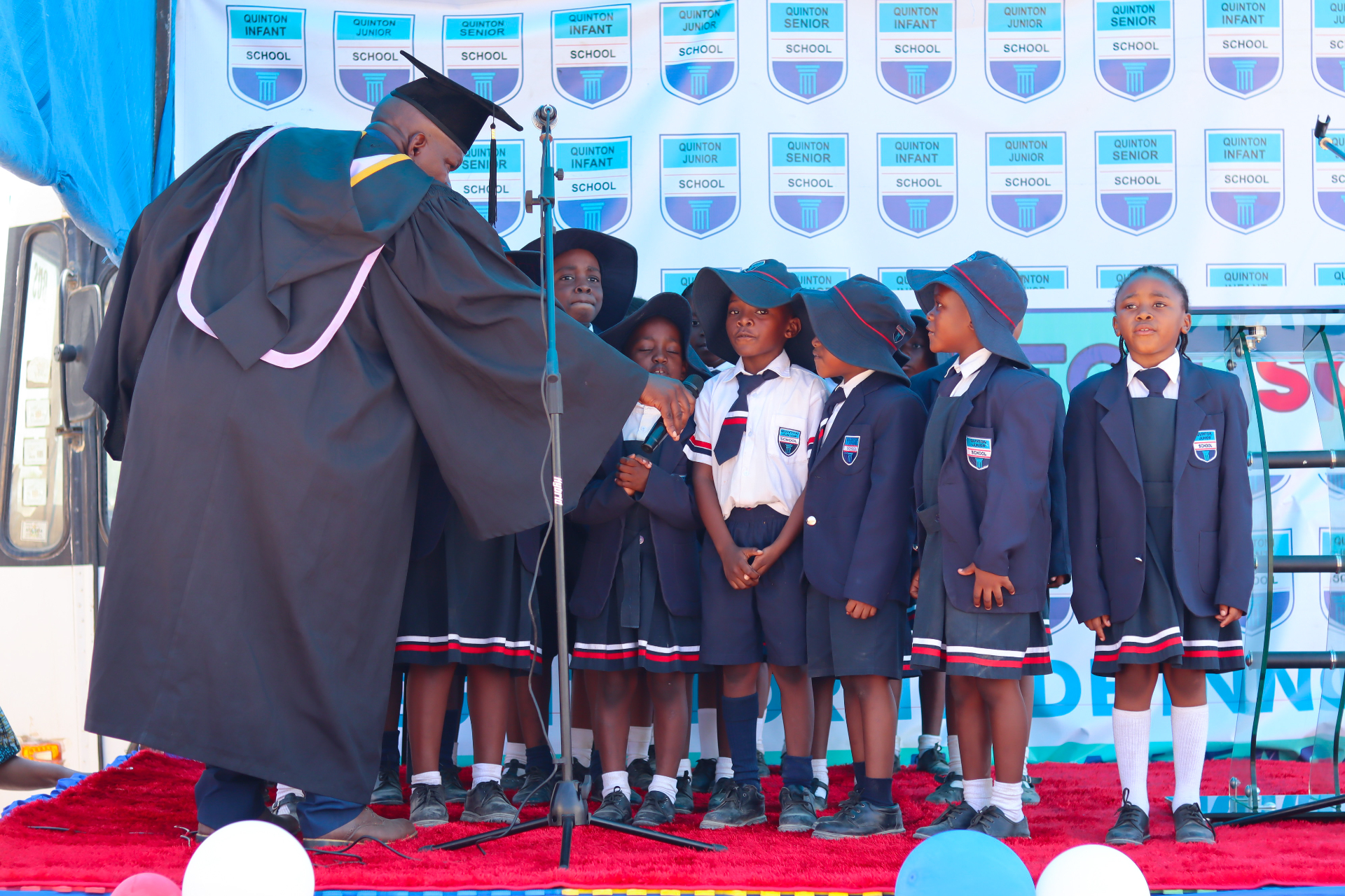 Junior pupils on stage at a school ceremony