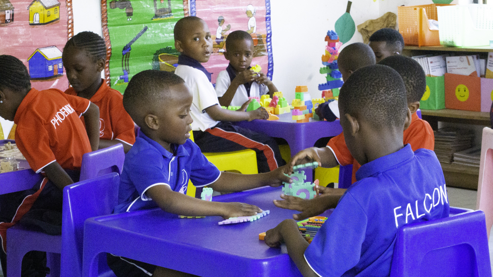 ECD learners building with colourful blocks